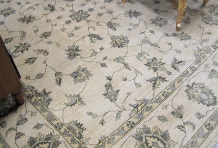 Appraisal: HAND KNOTTED ORIENTAL CARPET Indo-Persian overall meandering green leafy vine