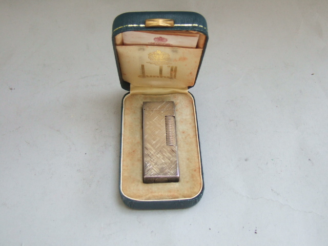 Appraisal: A silver plated rectangular Dunhill Rollagas lighter with engraved decoration