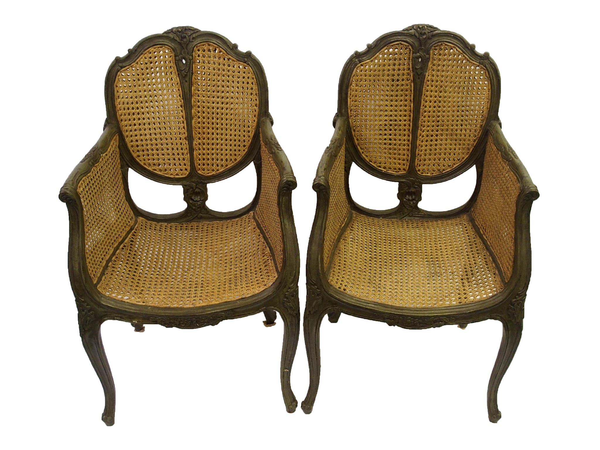 Appraisal: A pair of Bergere armchairswith carved foliate backs above scrolling