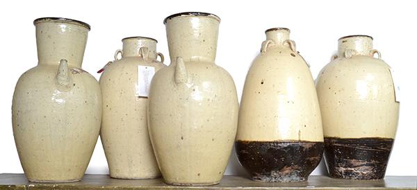 Appraisal: A COLLECTION OF FIVE CHINESE CREAM AND BLACK GLAZED EARTHENWARE