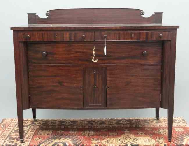 Appraisal: C 's mahogany sideboard having two drawers over central drawer