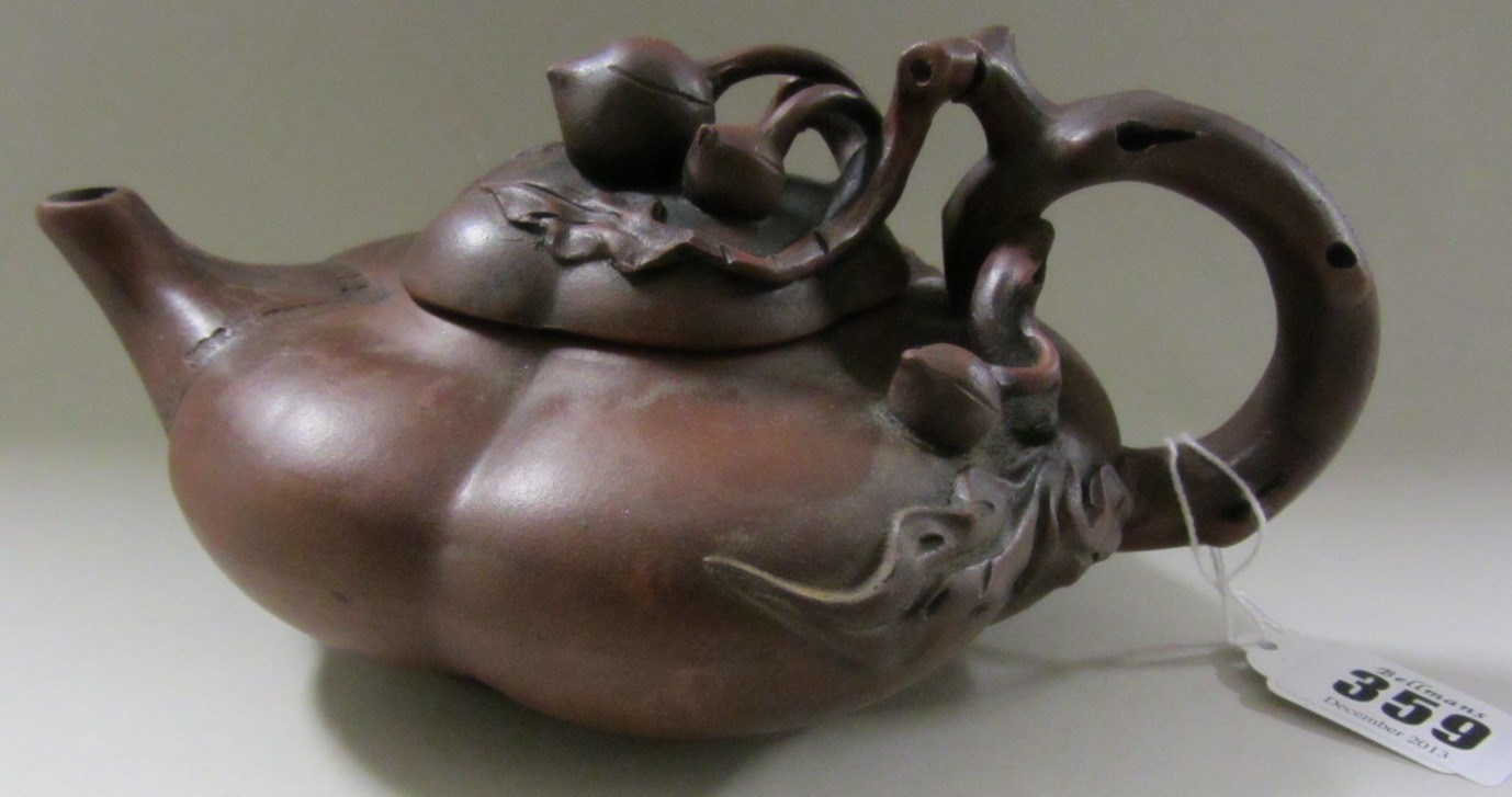 Appraisal: A Chinese Yixing teapot and cover of compressed lobed form