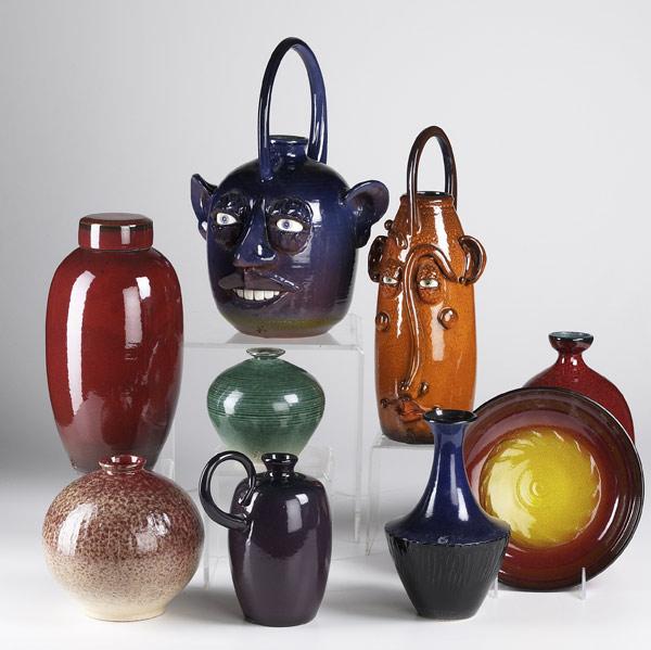 Appraisal: JIM SPIRES Nine pieces include two face jugs similar handled