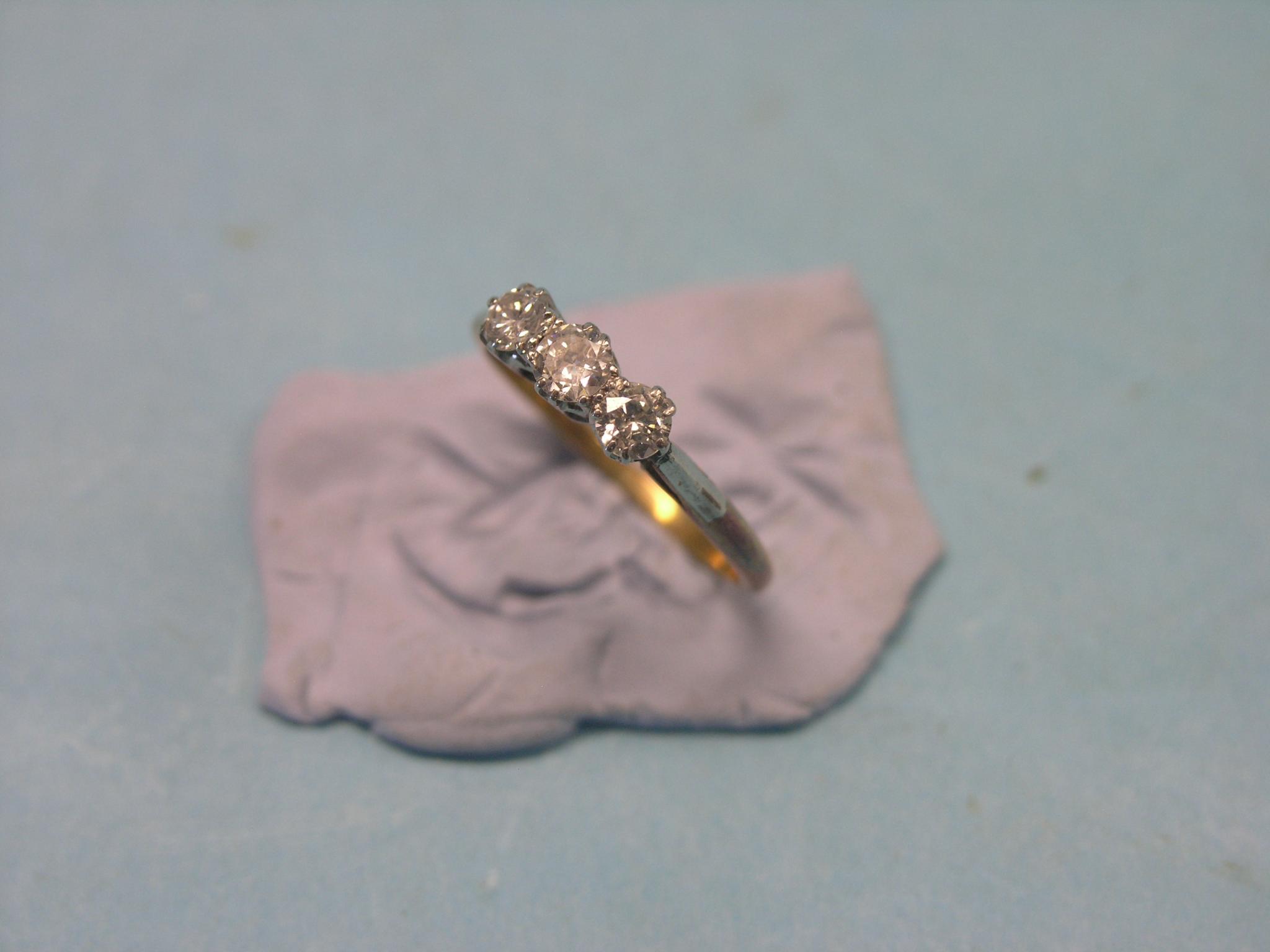 Appraisal: An ct gold and three-stone half-hoop ring platinum claw settings