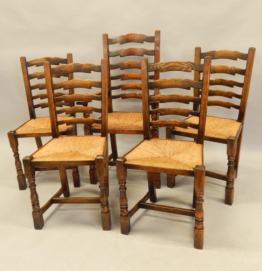 Appraisal: A set of five distressed oak ladder back chairs in