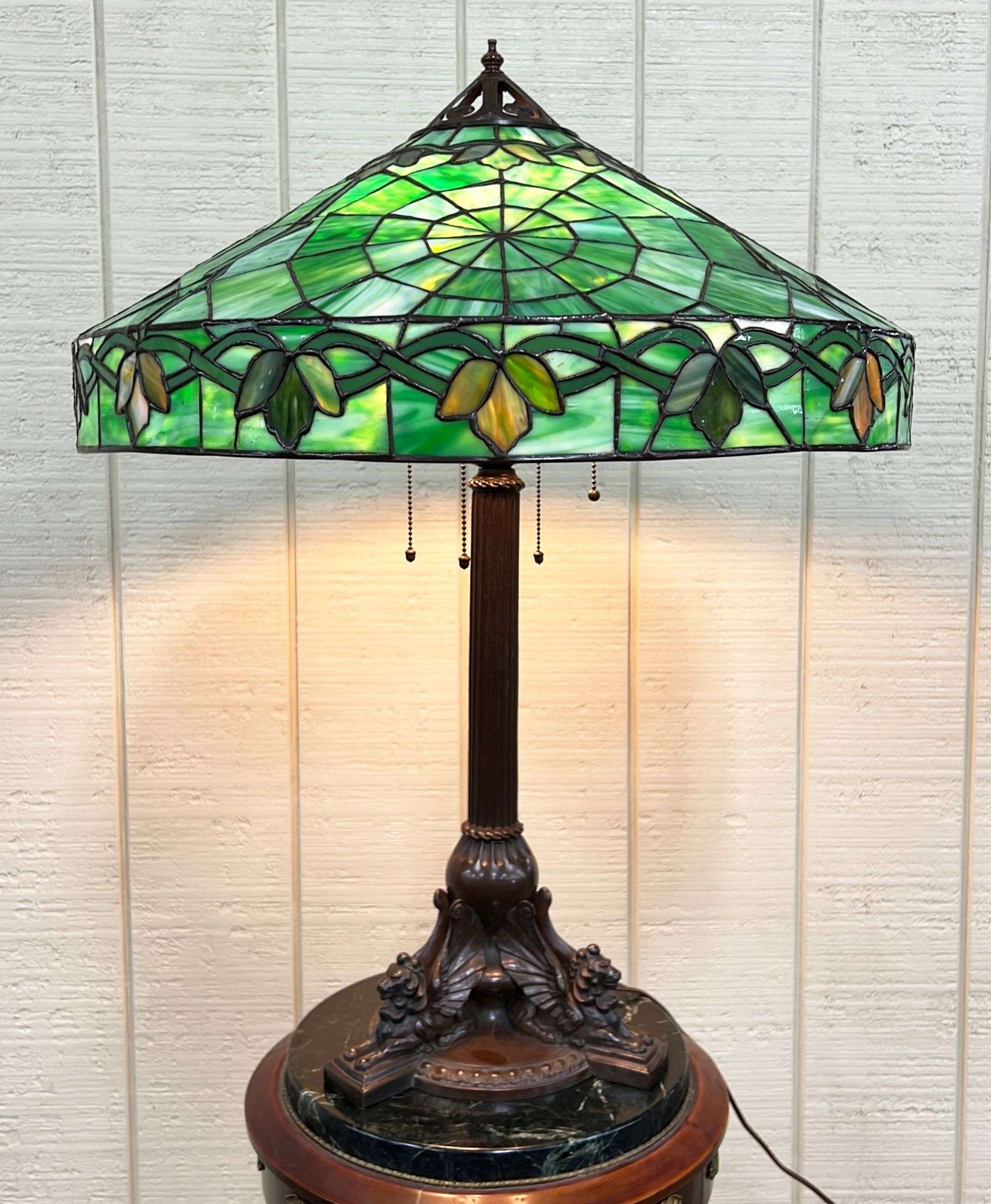 Appraisal: Handel bronze lion base stained glass shade lampEarly thC Shade