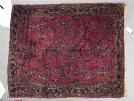 Appraisal: A Sarouk Wool Rug having a stylized foliate center medallion