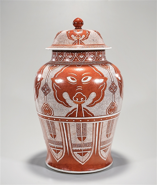 Appraisal: Tall Chinese red and white glazed porcelain covered vase animal