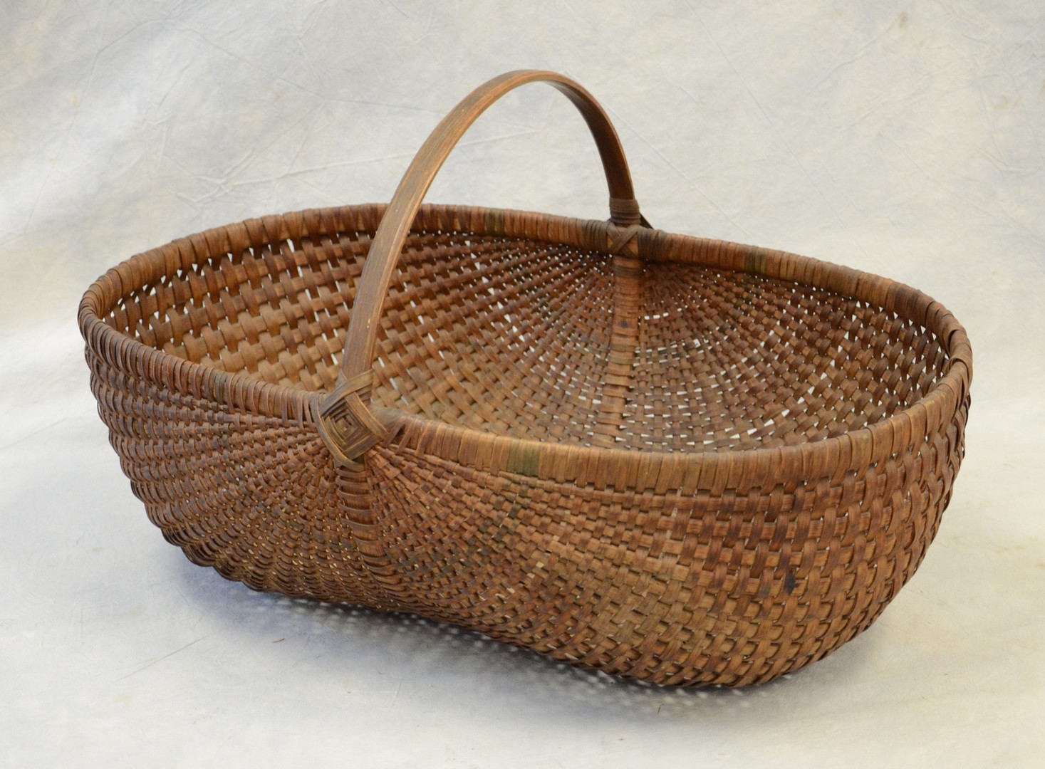 Appraisal: Oak splint kidney basket Southern origin died blue splint decoration