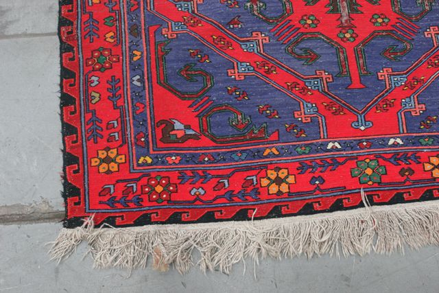 Appraisal: A woven rug in wool with diamond shaped medallions in