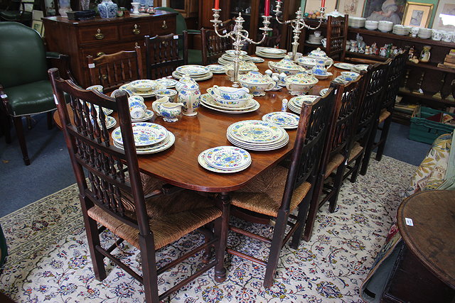 Appraisal: A REGENCY STYLE DINING TABLE standing on two tripod bases