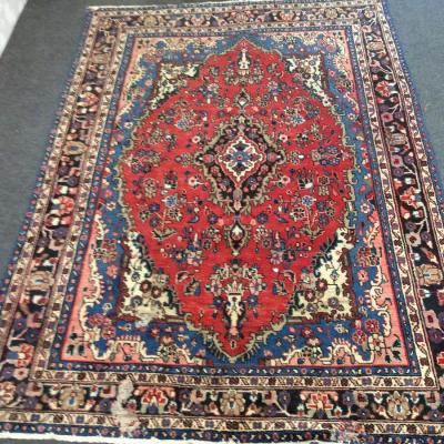 Appraisal: A Qashqai carpet with central red ground floral medallion within