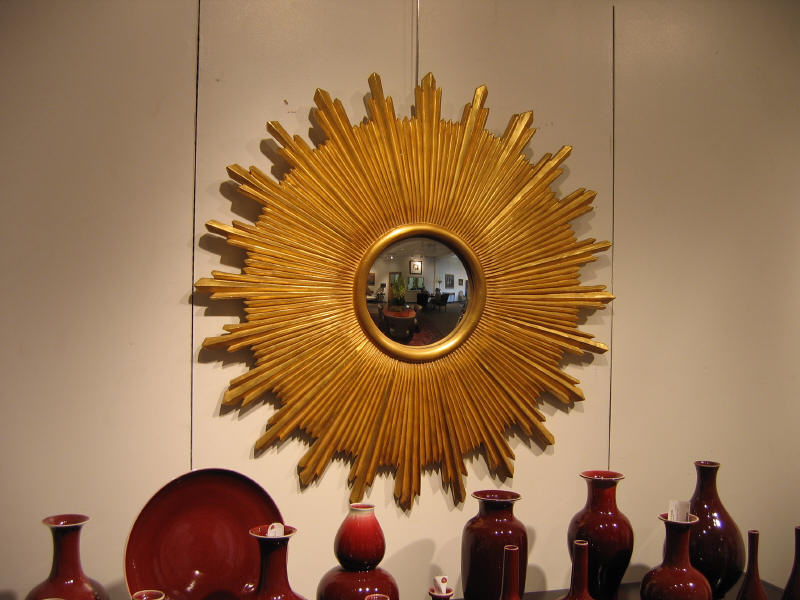 Appraisal: GILT FRAMED SUNBURST WALL MIRROR with convex central mirror d