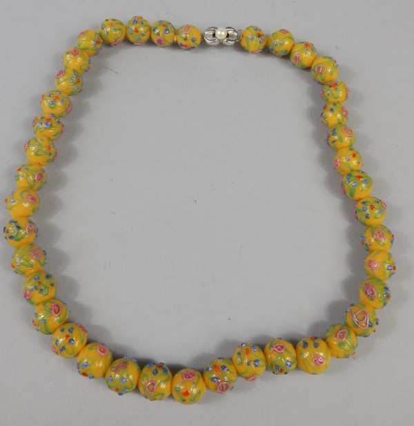 Appraisal: A glass bead necklace with trail decoration of flowers etc