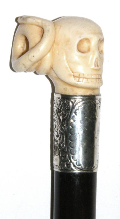 Appraisal: Edwardian rosewood silver mounted walking cane with a carved skull