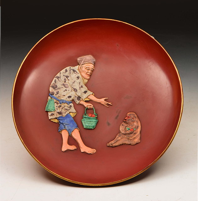 Appraisal: Japanese Kutani red lacquer glazed dishdecorated Sarumawashi and monkey Meiji