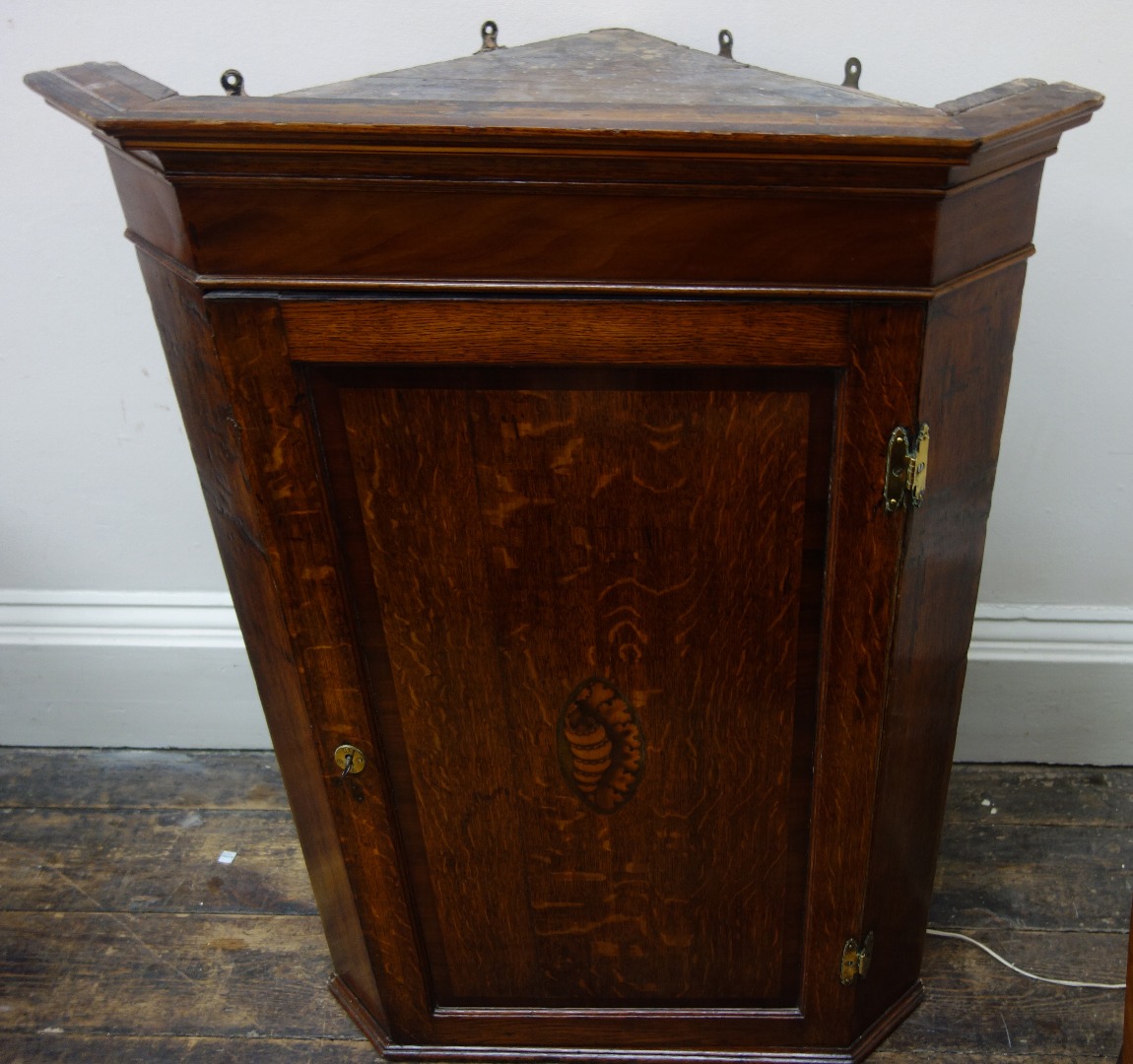 Appraisal: A George III oak and mahogany wall hanging corner cabinet