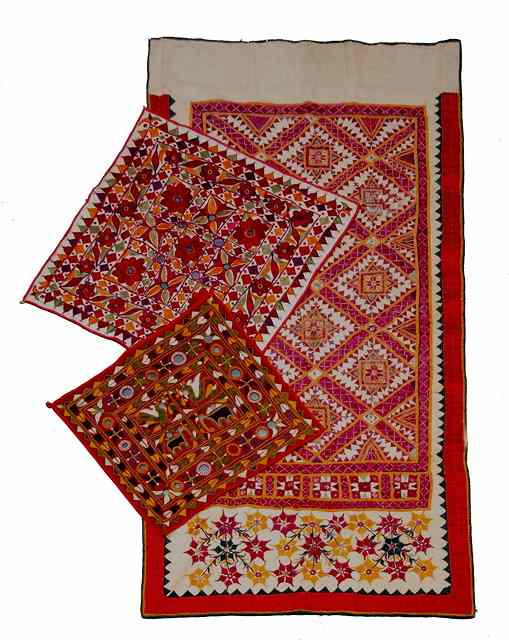 Appraisal: THREE GUJARATI NEEDLEWORK WALL HANGINGS with mirrored geometric and floral