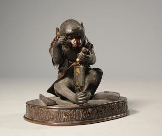 Appraisal: Japanese Meiji period bronze seated monkey inspecting his inro which