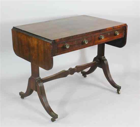 Appraisal: A Regency rosewood sofa table with two drawers on standard