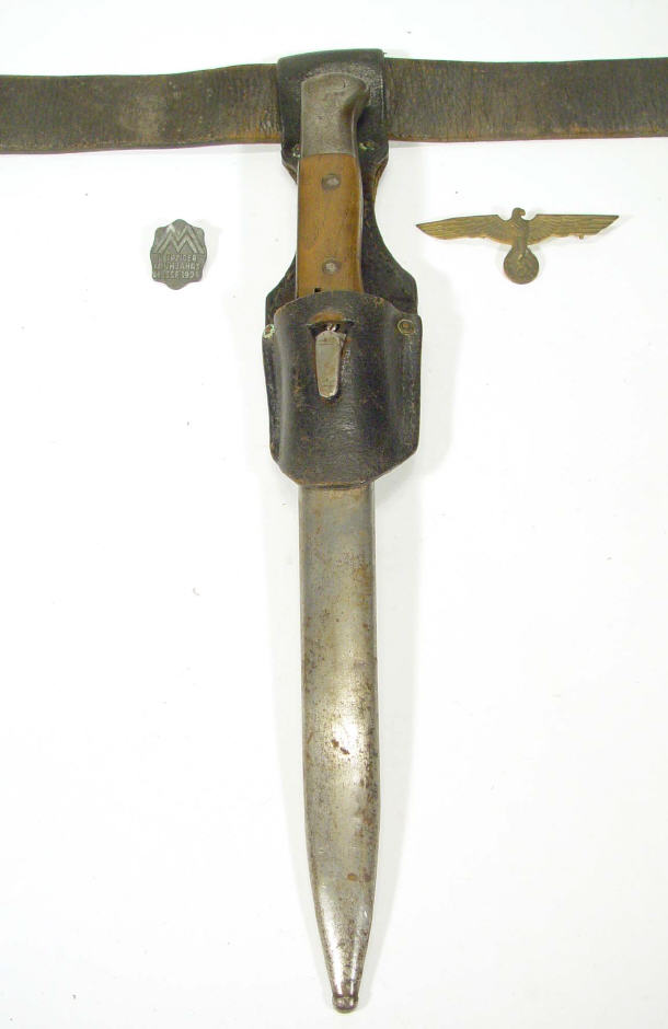 Appraisal: German military bayonet in scabbard with belt a Nazi brooch