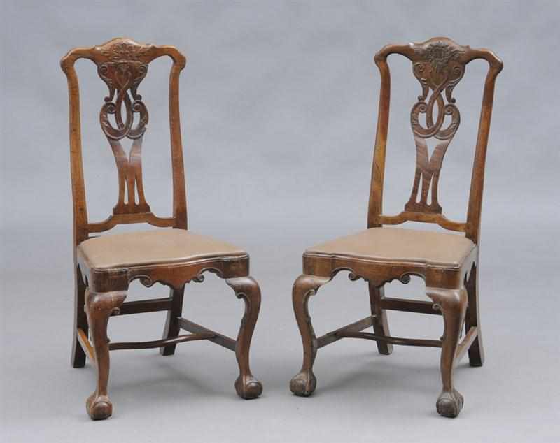 Appraisal: PAIR OF PORTUGUESE ROCOCO CARVED WALNUT SIDE CHAIRS The shaped