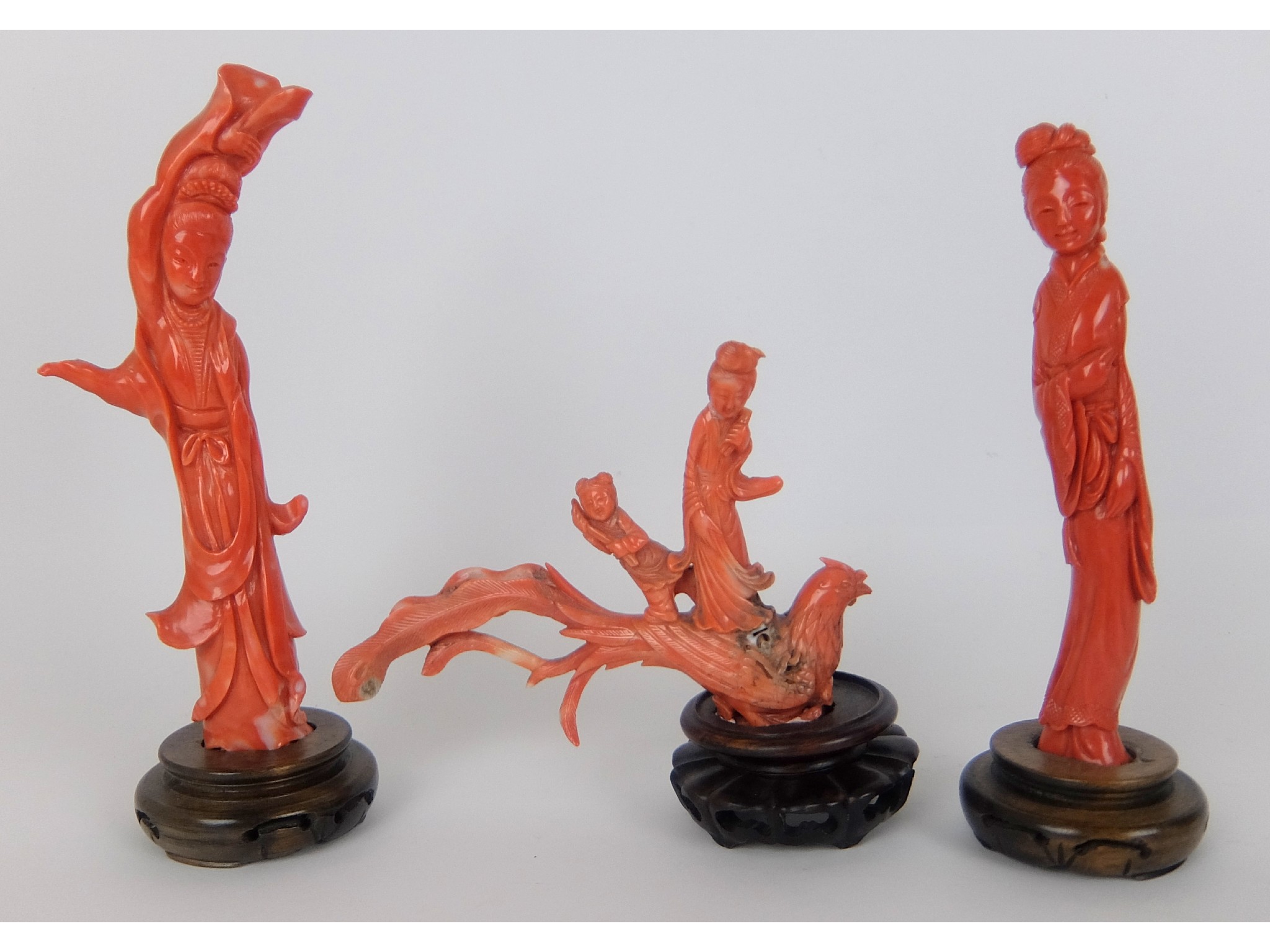 Appraisal: Three Chinese coral carvingscomprising two female figures on stands and