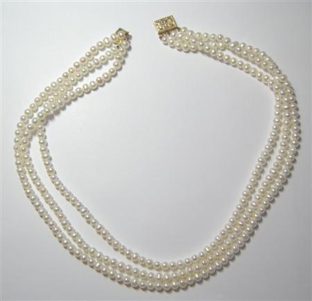 Appraisal: A three strand cultured pearl necklace gold clasp with Lotus