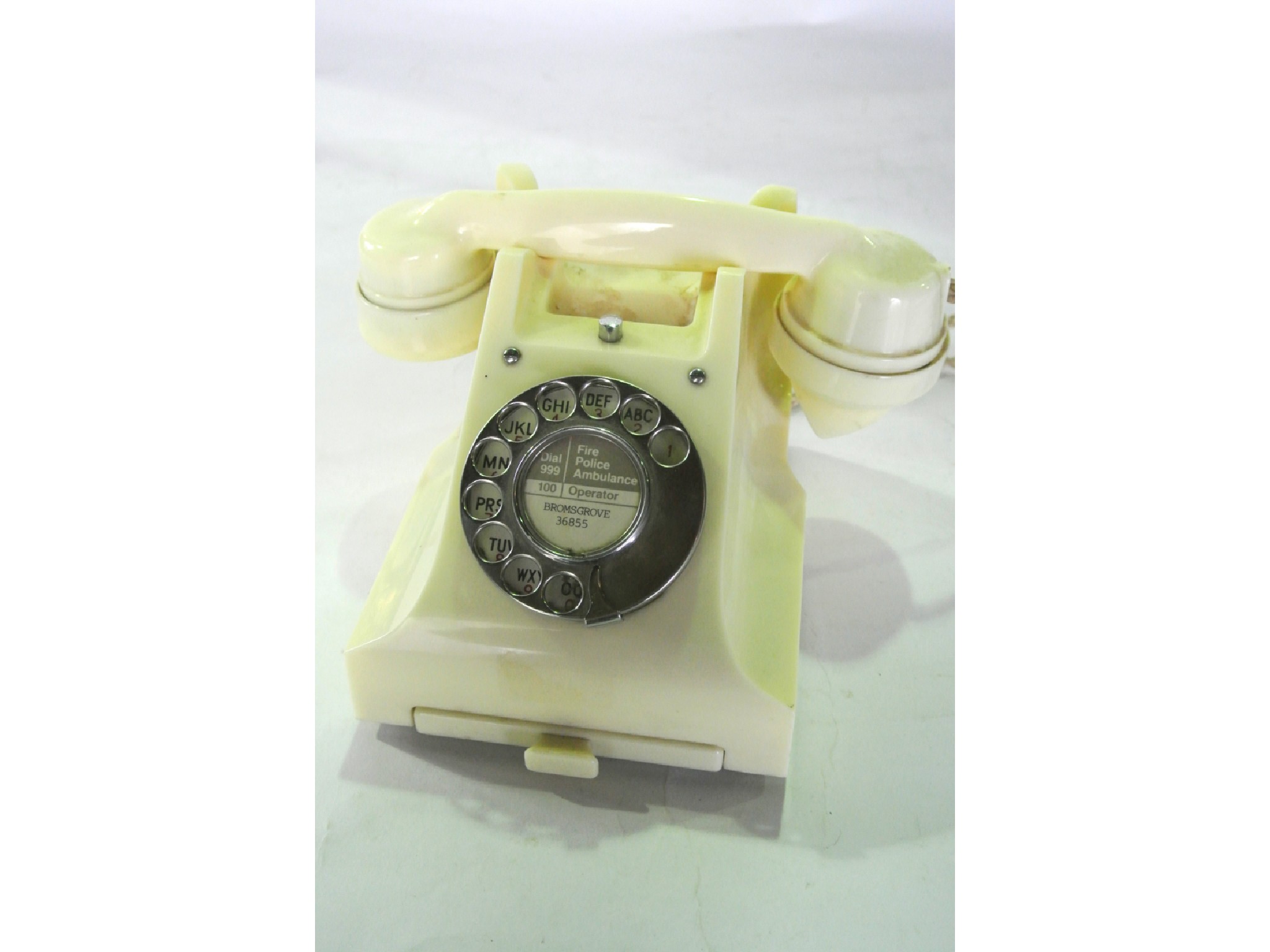 Appraisal: A vintage cream coloured bakelite telephone with integral drawer numbered