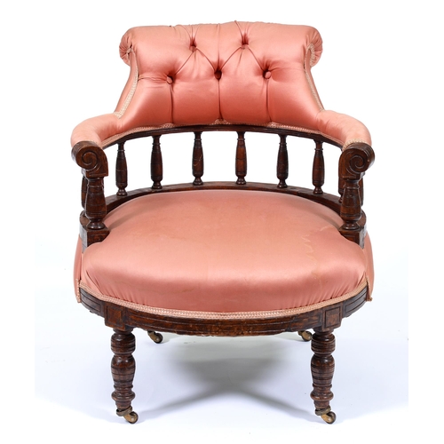 Appraisal: An Edwardian stained oak salon chair with buttoned rail to