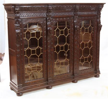 Appraisal: A th century carved and stained oak bookcase the projected