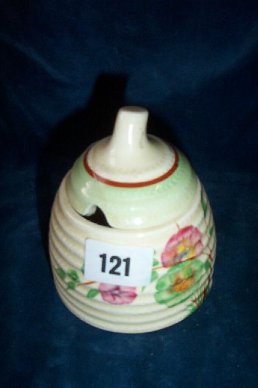 Appraisal: A Clarice Cliff conical shaped honey pot and cover in