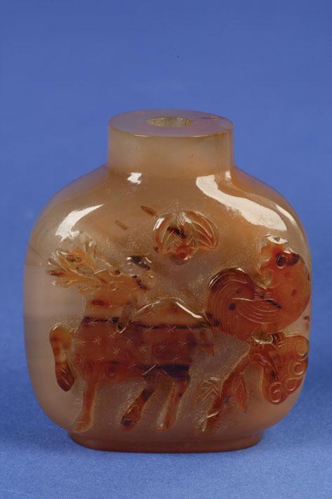 Appraisal: A CHALCEDONY BOTTLE carved with a deer and a chicken