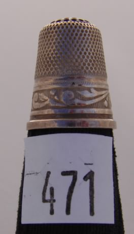 Appraisal: Sterling thimble with decorative band and red stone cap