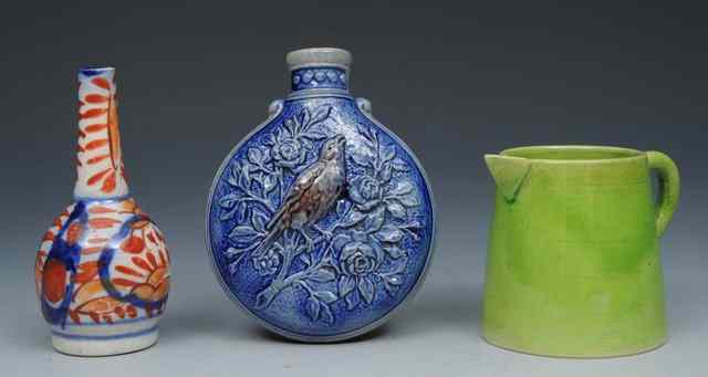 Appraisal: A WESTERWALD MINIATURE FLASK relief moulded with birds a miniature