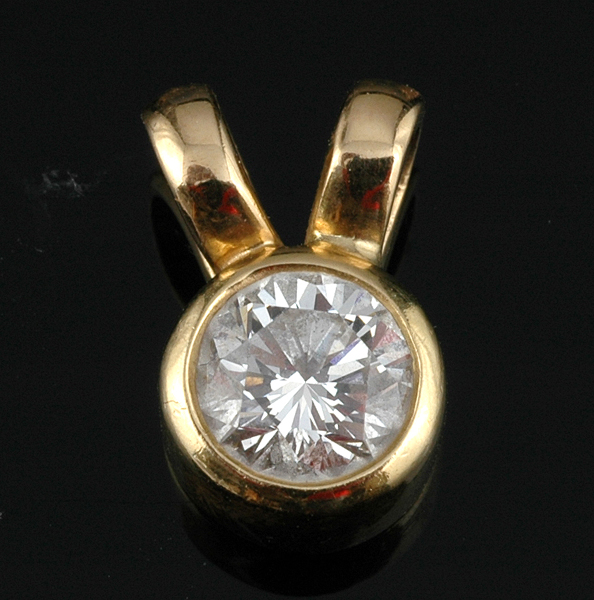 Appraisal: A DIAMOND SOLITAIRE PENDANT The round brilliant cut diamond weighing