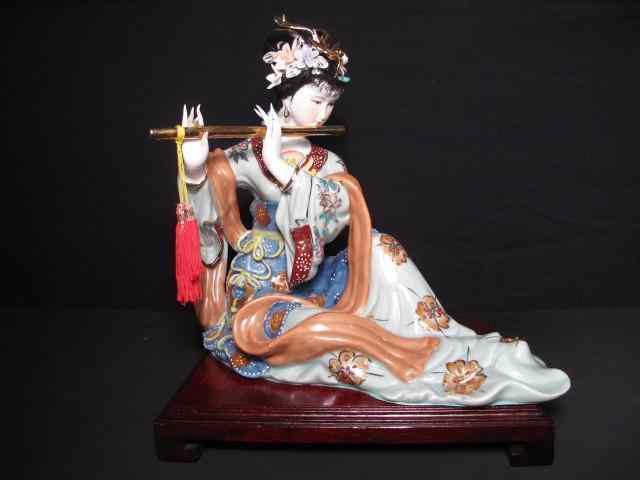 Appraisal: Ceramic figure of an Asian musician On wooden base Measures