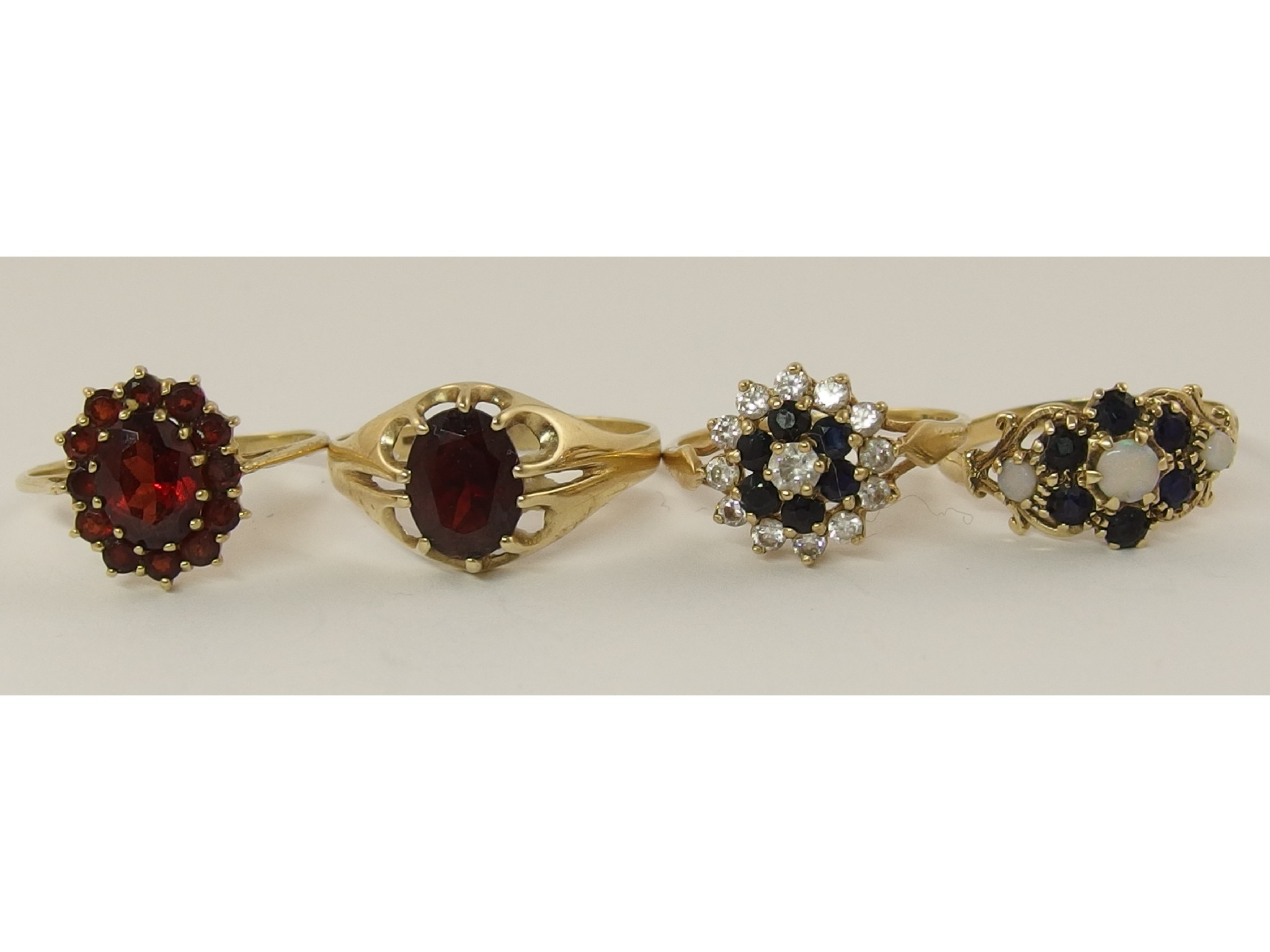 Appraisal: Four ct gem set rings to include garnet opal and