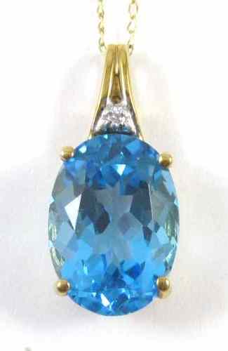 Appraisal: BLUE TOPAZ AND DIAMOND PENDANT NECKLACE suspended on a yellow