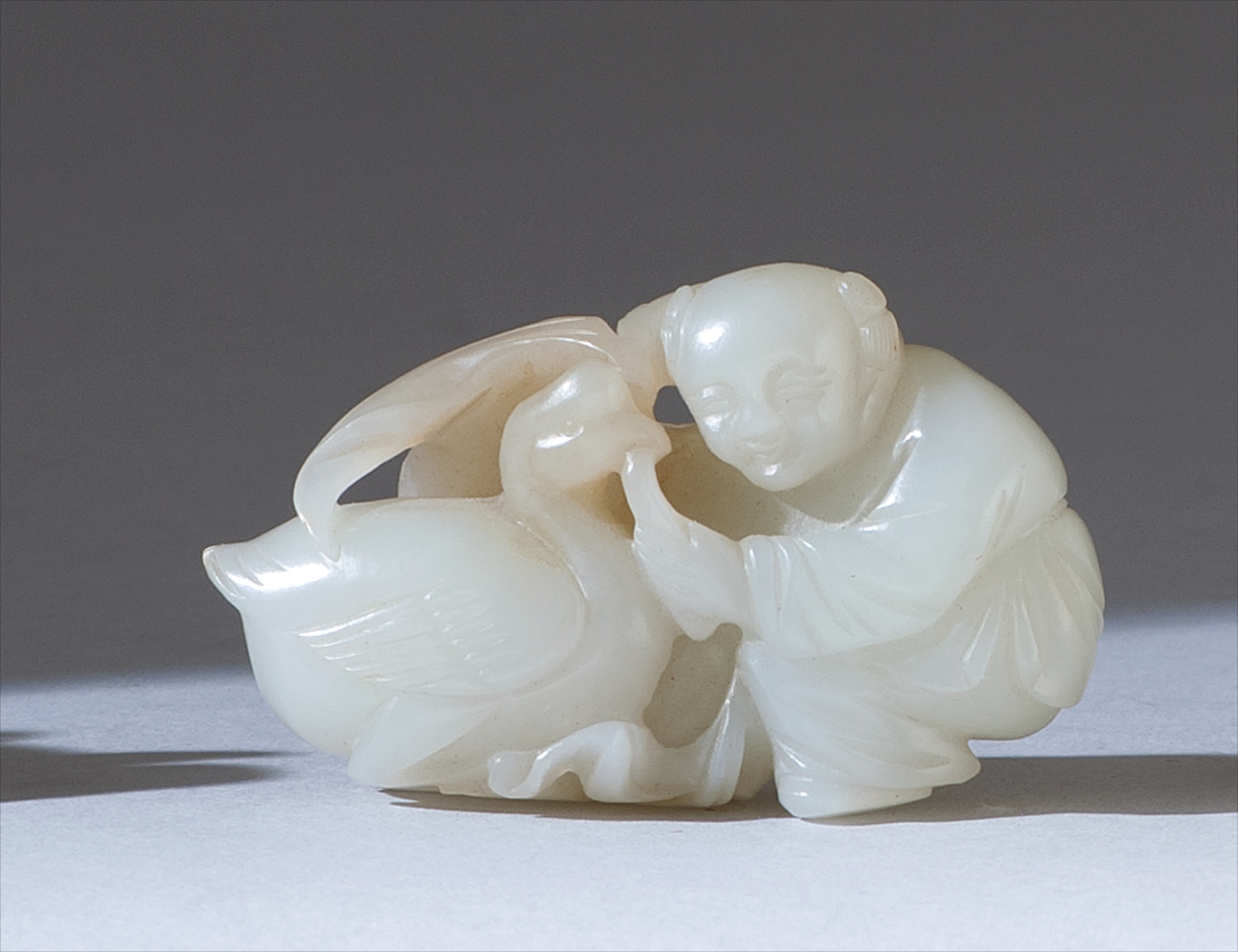 Appraisal: WHITE JADE CARVING Circa In the form of a boy