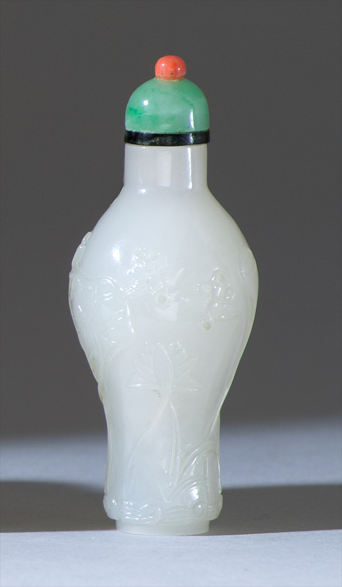 Appraisal: WHITE JADE SNUFF BOTTLE In amphora form with relief lotus