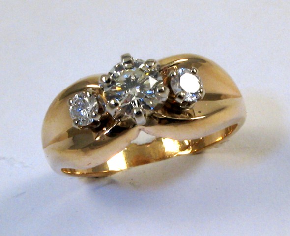 Appraisal: DIAMOND AND FOURTEEN KARAT GOLD RING centering a round brilliant-cut