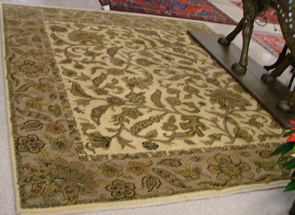 Appraisal: HAND KNOTTED ORIENTAL CARPET Indo-Persian overall floral design on khaki