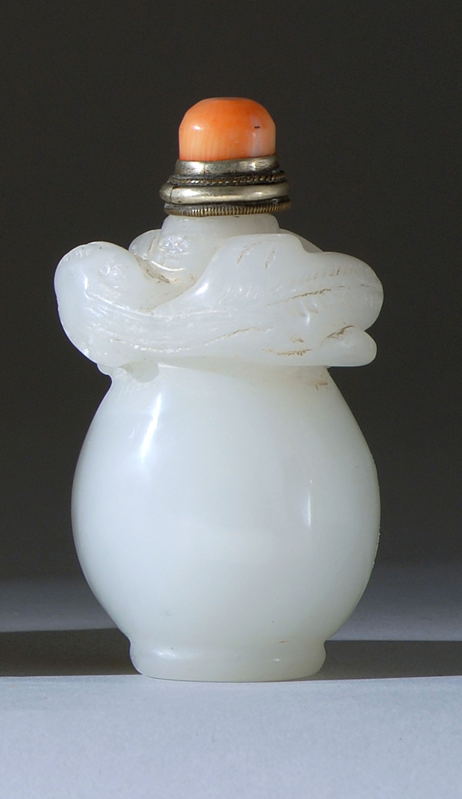 Appraisal: WHITE JADE SNUFF BOTTLE In pear shape with relief dragon