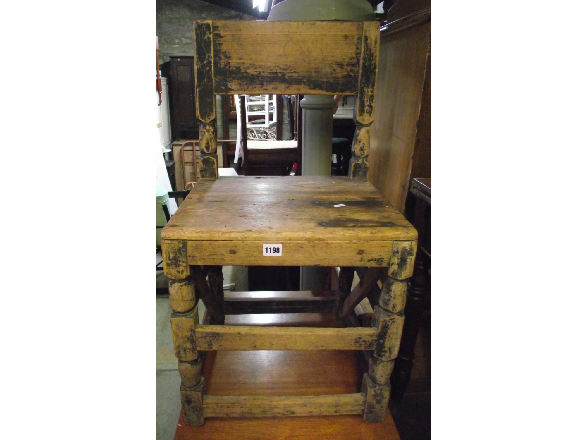 Appraisal: An antique pine chair with wide rail back over a