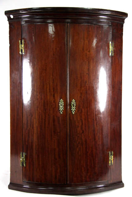 Appraisal: A George III mahogany bowfront hanging corner cupboard circa with