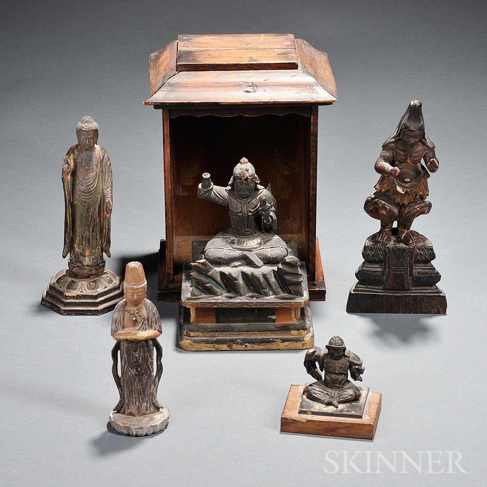 Appraisal: Five Wood Statuettes Japan a standing Buddha on a half-lotus