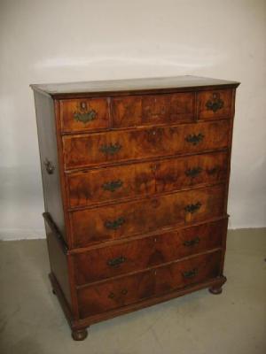 Appraisal: A WALNUT CHEST ON CHEST the banded top with moulded