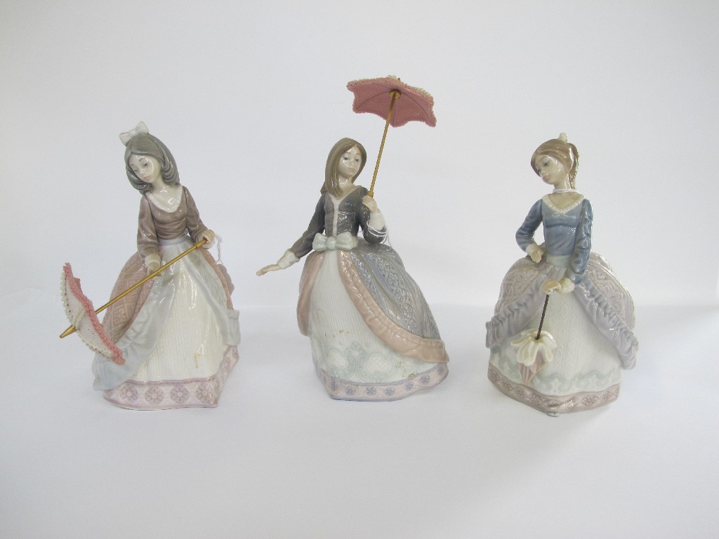 Appraisal: Three Lladro figures of women each with a parasol