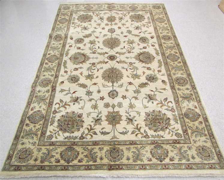 Appraisal: HAND KNOTTED ORIENTAL CARPET Pakistani-Persian overall floral design on buff